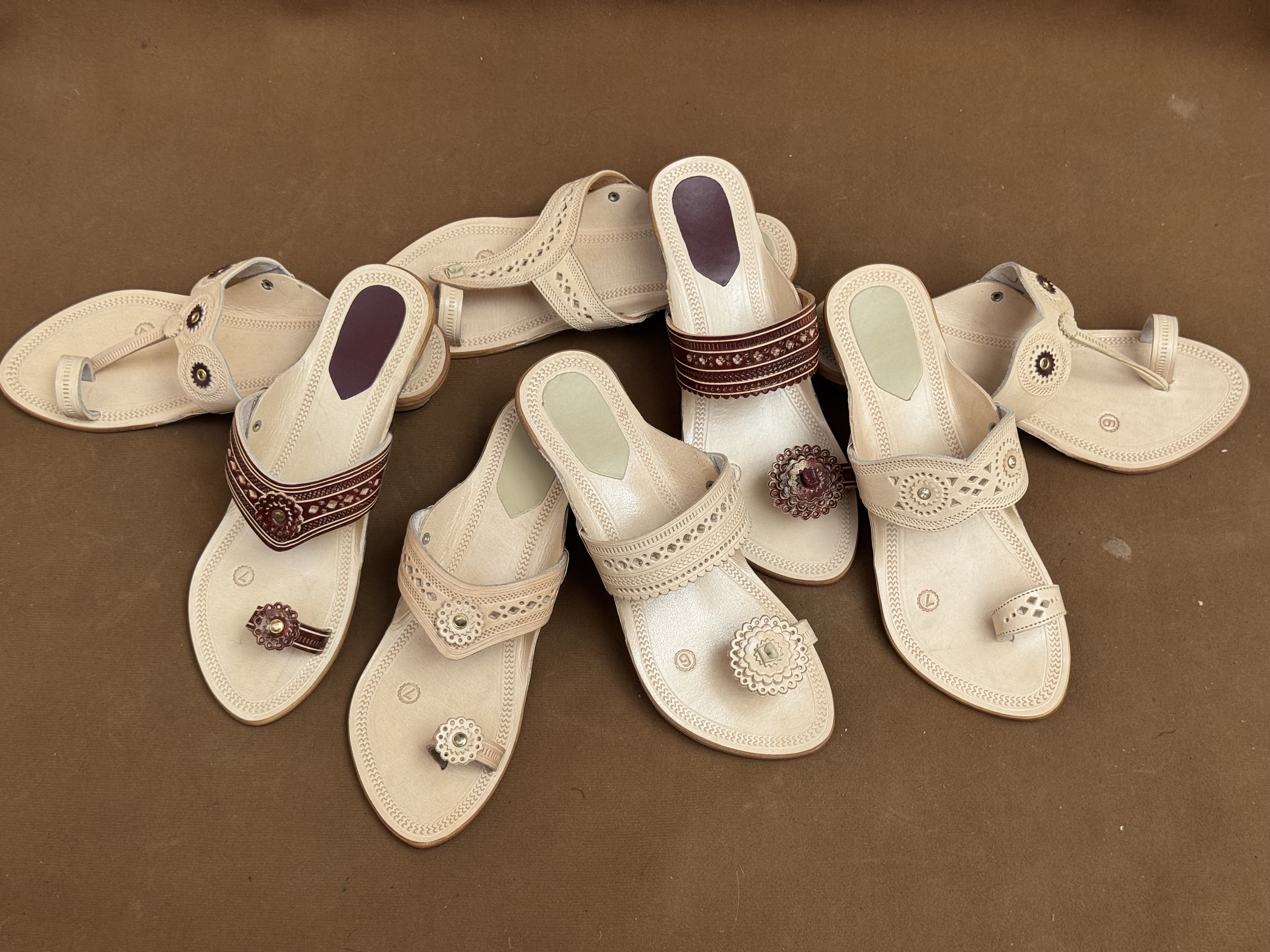 Assorted leather chappals in natural tan and maroon